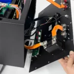 Open device showing internal wiring, orange cables, and a 220A DC MCCB 2-pole battery isolator for DIY battery boxes.